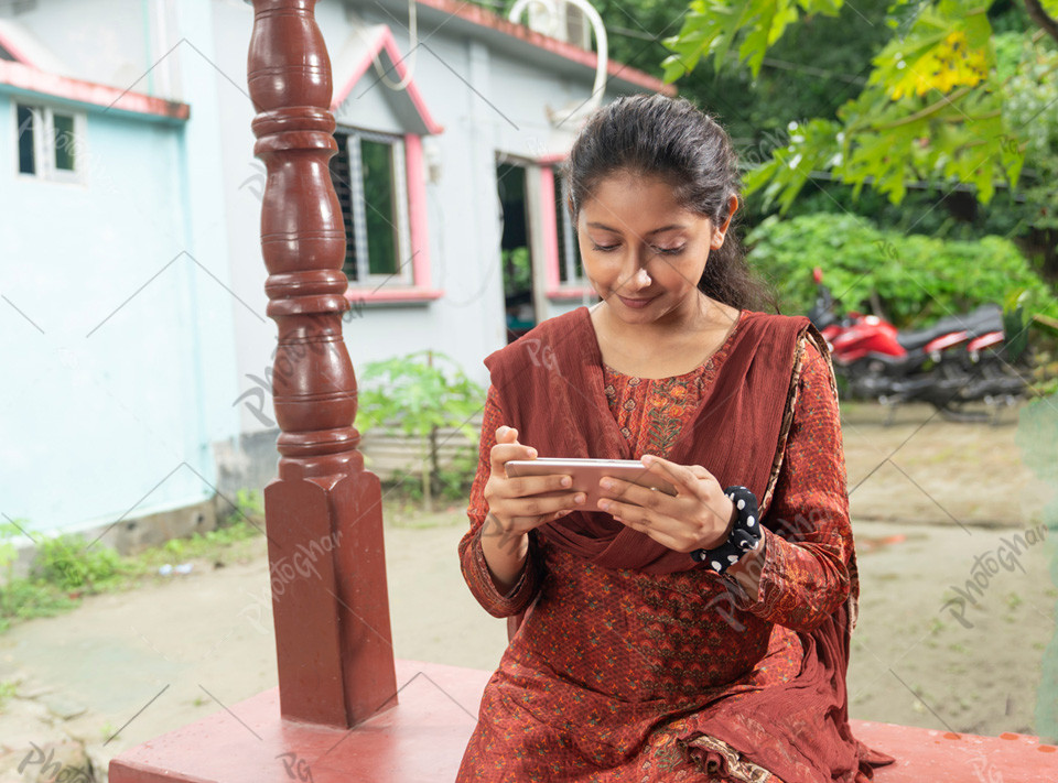 Young adult girl of South Asia playing games