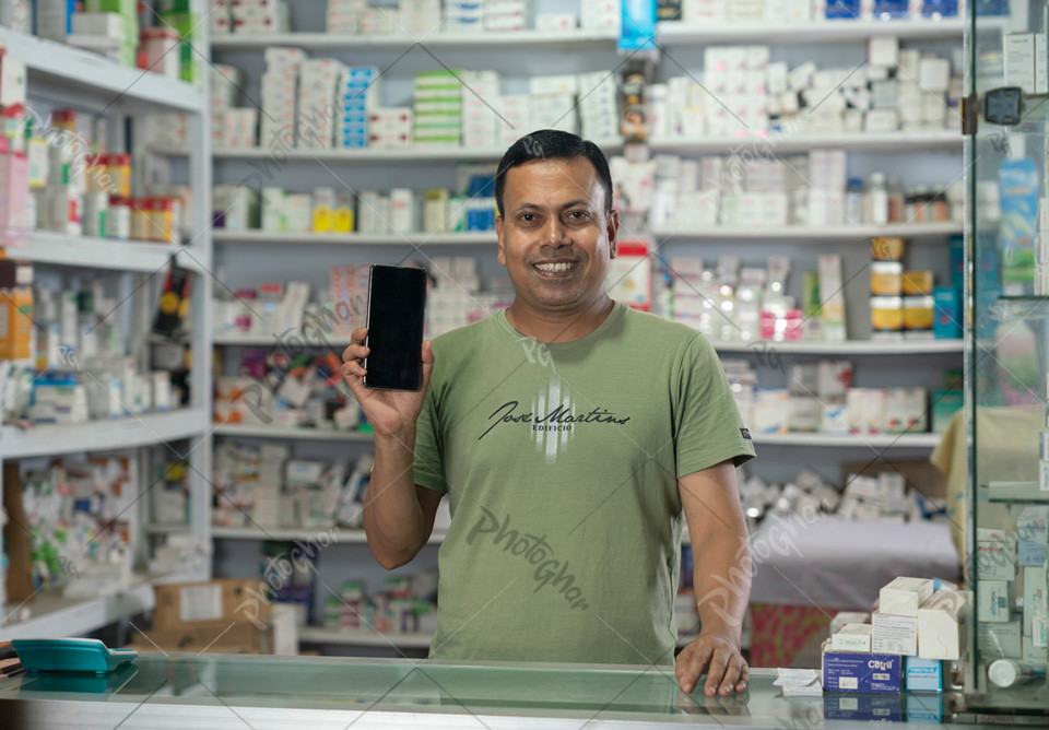 Young adult pharmacist using mobile apps