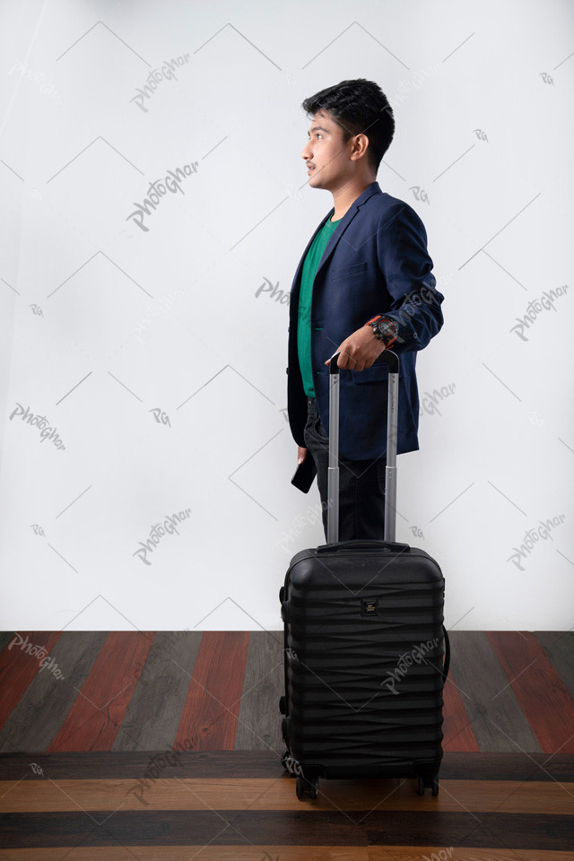 Young gentleman waiting with luggage bag