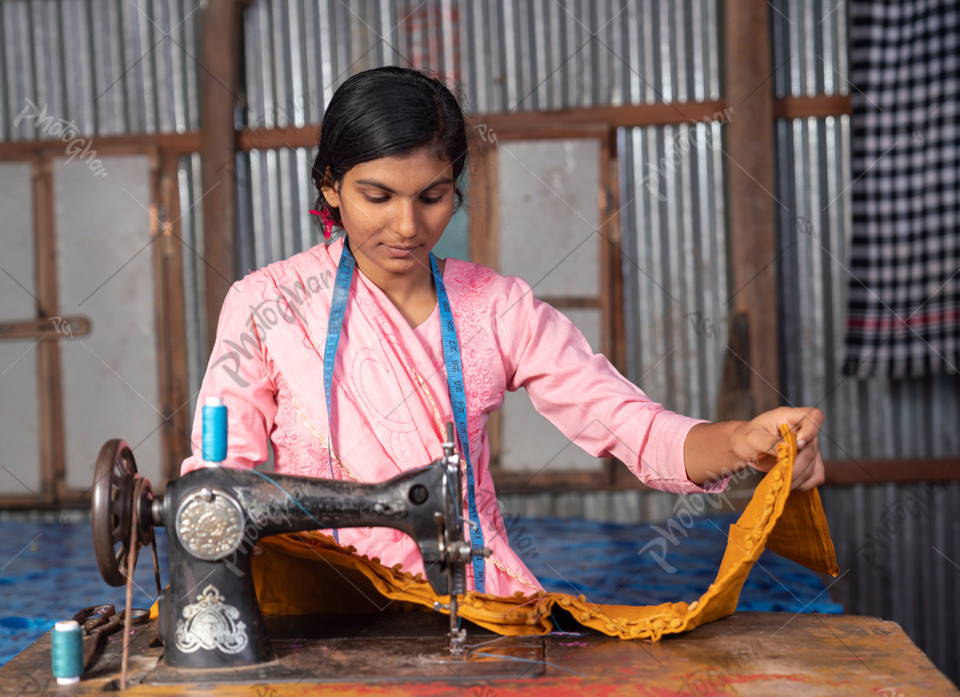 Young girl using sewing machine