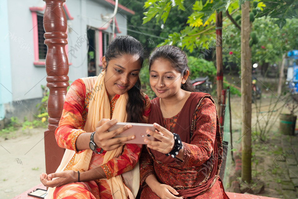 Young ladies using smartphone to study online