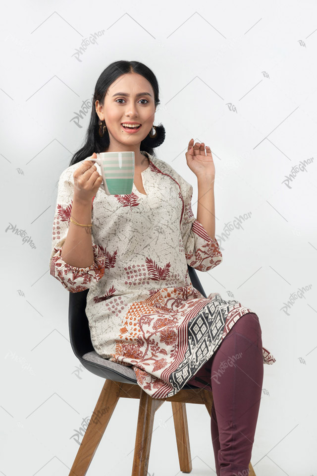 Young lady holding coffee cup