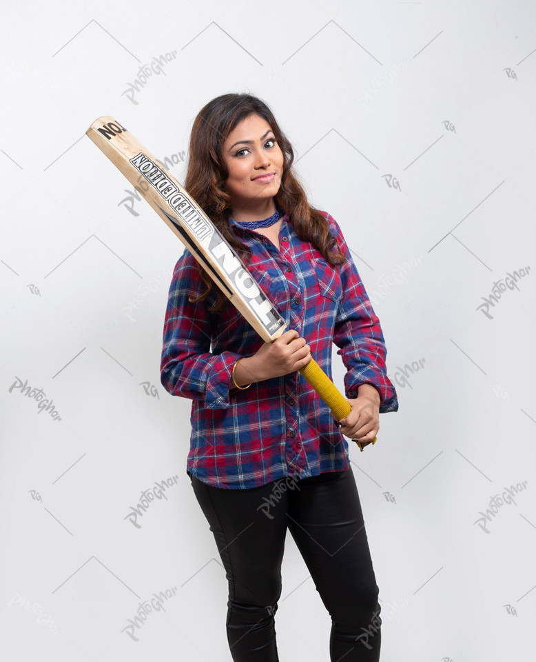 Young woman cricketer holding bat