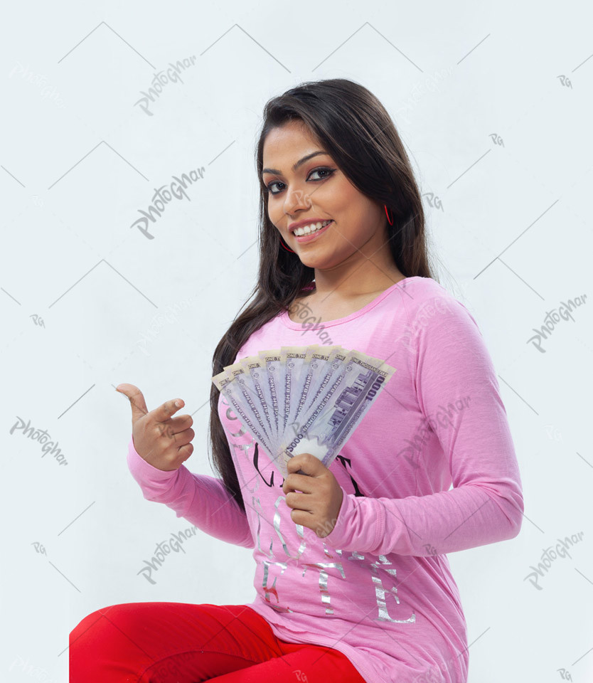 Young woman pointing finger at money