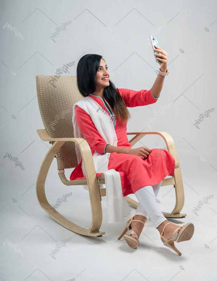 Young woman taking a selfie at home