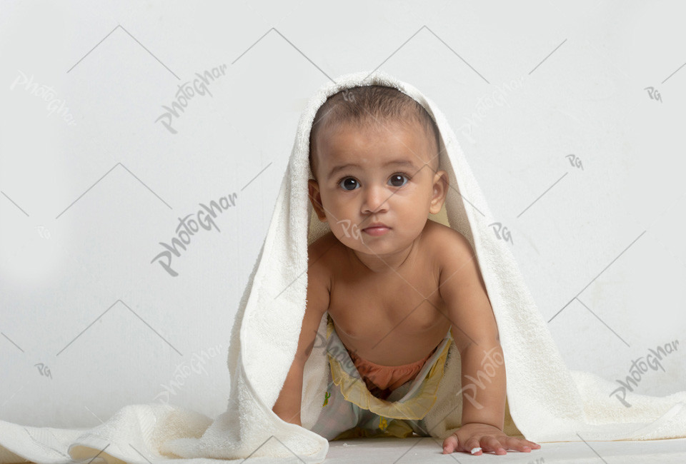 baby playing with towel