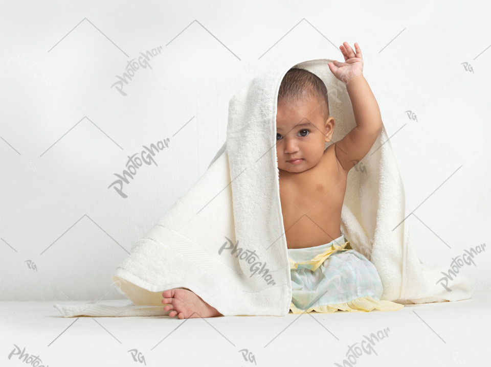 baby playing with towel