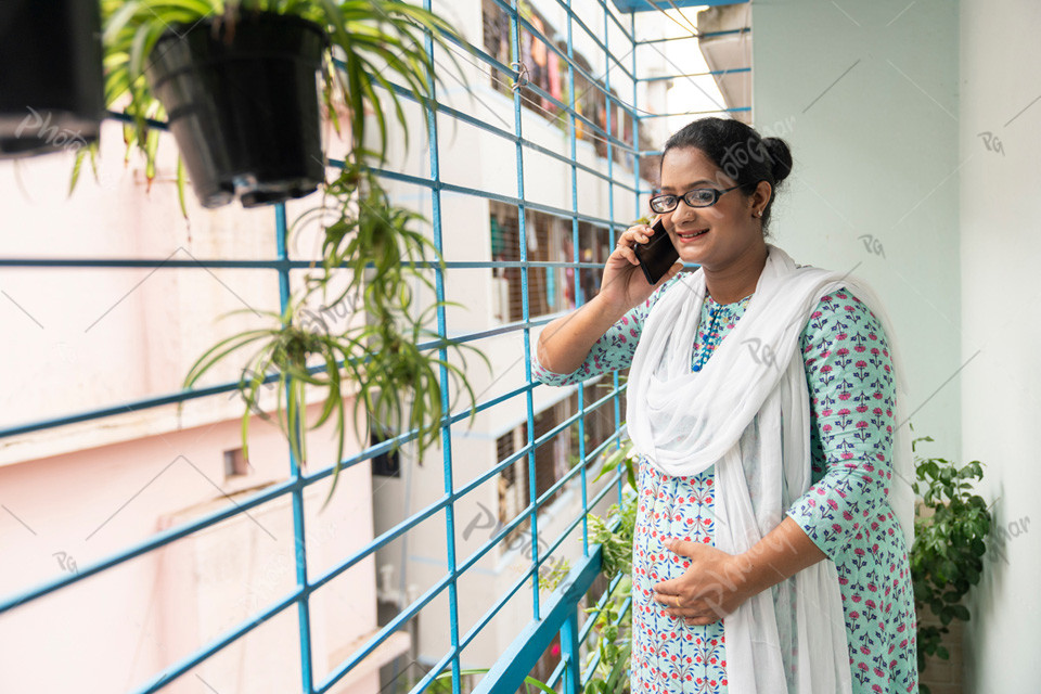 beautiful pregnant woman talking smartphone