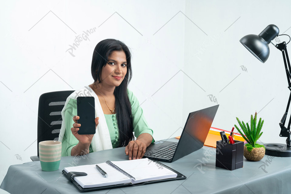 businesswoman showing mobile screen