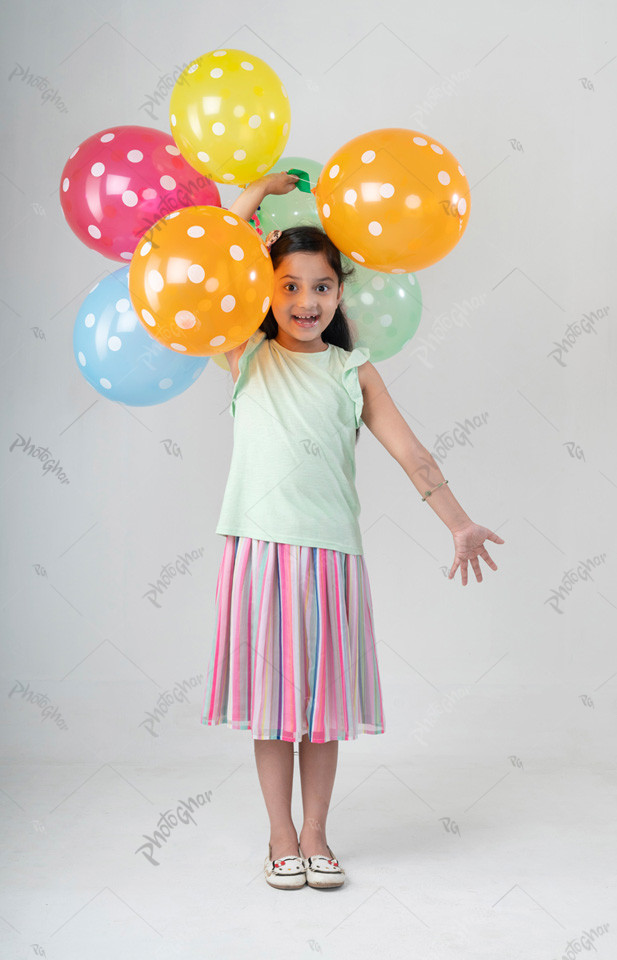 child artist playing with colorful balloon