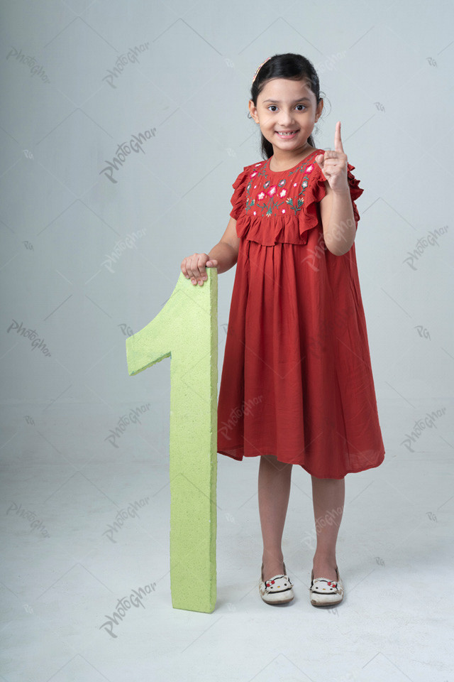 child holding and showing number one cutout