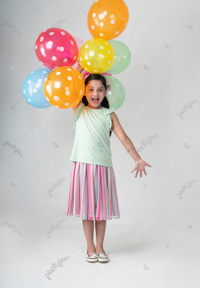 child playing with colorful balloon