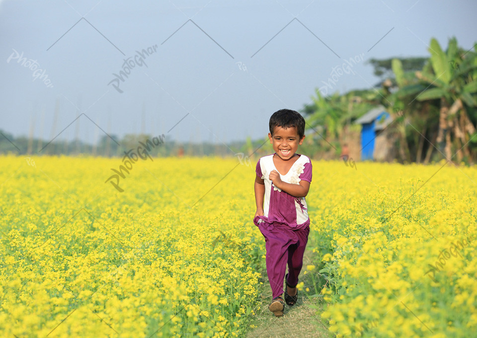 child running in  the mustard field