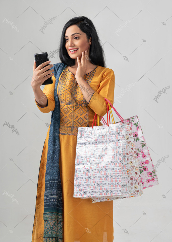 excited young woman holding mobile phone