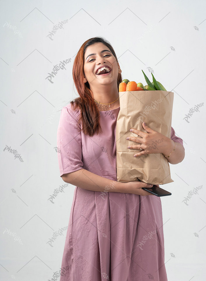 exhilarated smiling housewife holding paper bag