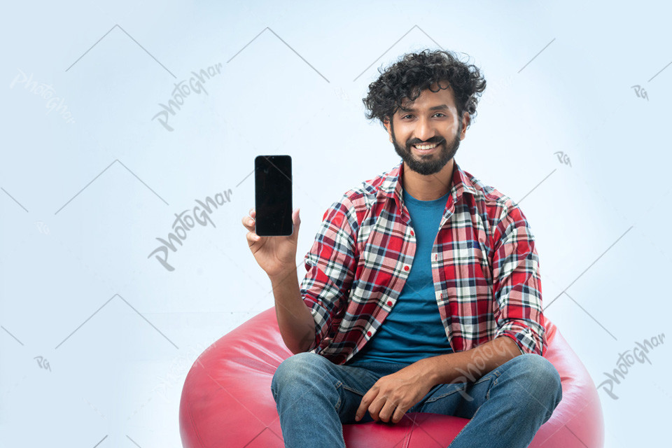 joyful Bangladeshi man showing cell phone