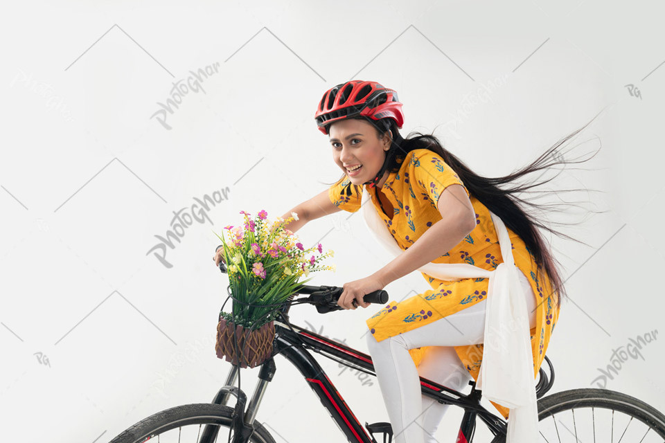 joyful college girl riding bicycle