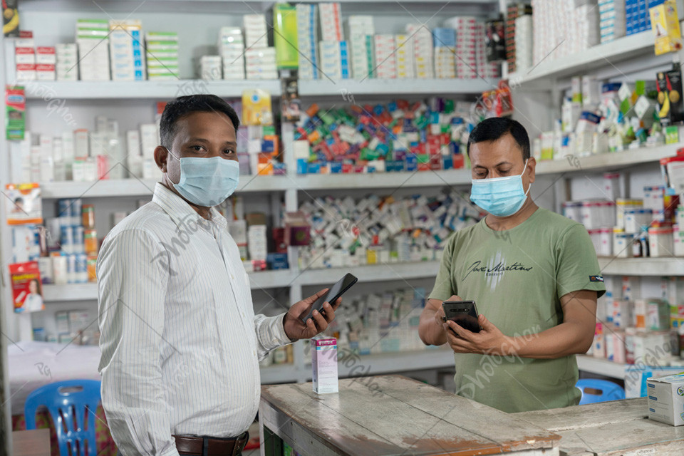 pharmacy salesman and customer wearing mask