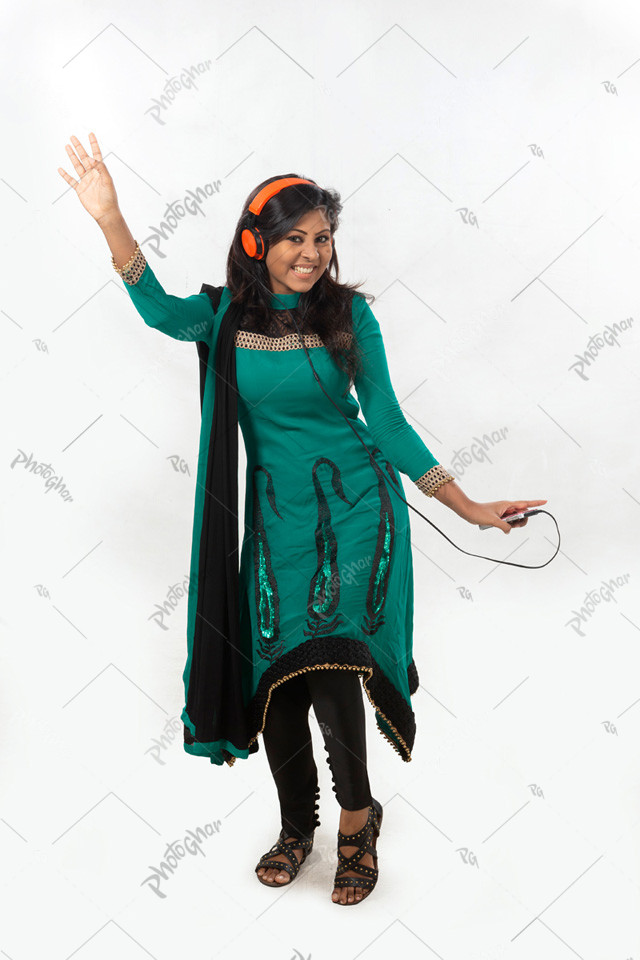 south asian woman listening to music