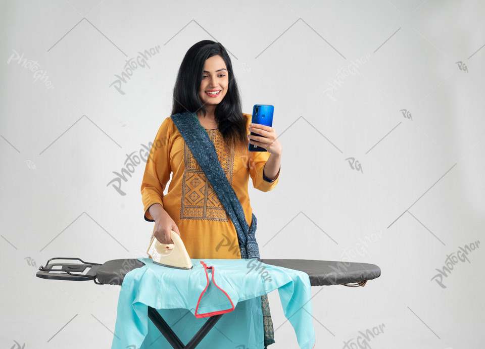 young happy woman with electric iron talking